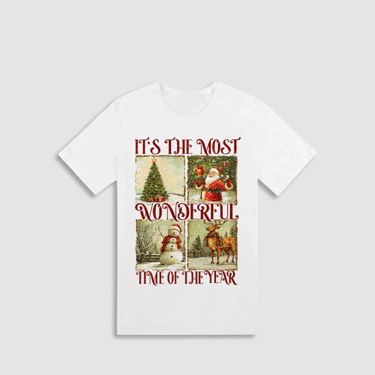 A white t-shirt with a graphic design featuring a Christmas tree, Santa Claus, a snowman, and a reindeer, along with the text "It's the most wonderful time of the year" and "Time of the year" printed on it.
