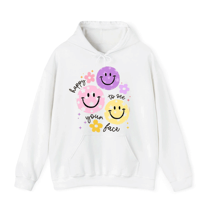 A white hoodie with a graphic design featuring three smiling faces and the text "happy to see your face" written around them.
