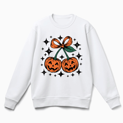 A white sweatshirt with a graphic design featuring two jack-o'-lanterns and a bow, surrounded by stars.