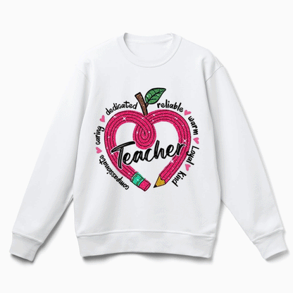 A white sweatshirt with a graphic design featuring an apple with a heart shape and the word "Teacher" written inside it.