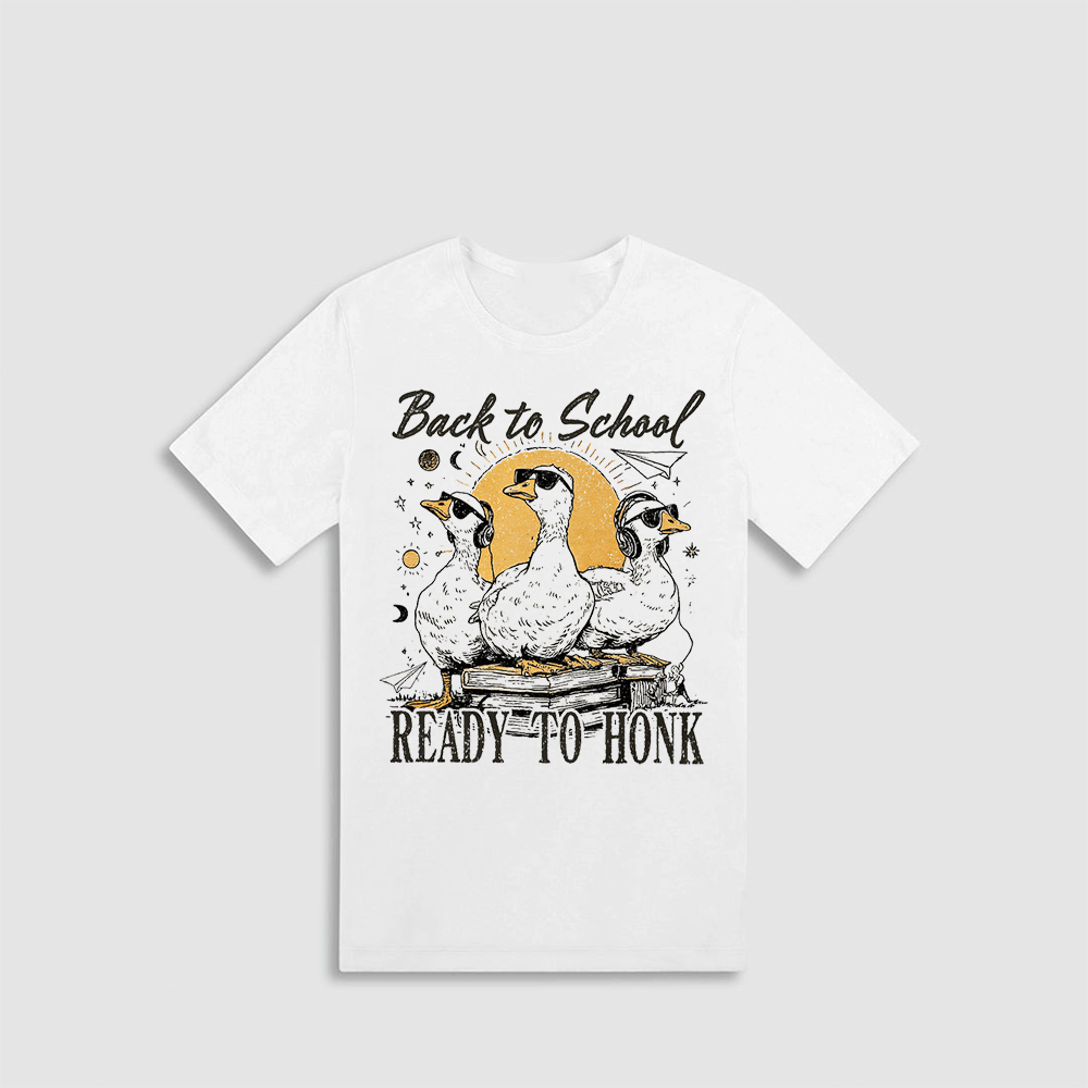 A white t-shirt with a graphic design featuring three cartoon ducks and the text "Back to School READY-TO-HONK" printed on it.