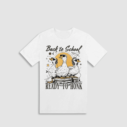 A white t-shirt with a graphic design featuring three cartoon ducks and the text "Back to School READY-TO-HONK" printed on it.