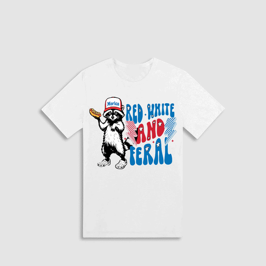 A white t-shirt with a graphic design featuring a raccoon wearing a baseball cap and holding a hot dog, along with the text "Red-white and red-white and red-white and".