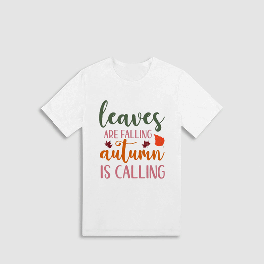 A white t-shirt with a colorful graphic design that says "leaves are falling autumn is calling" in a stylized font.