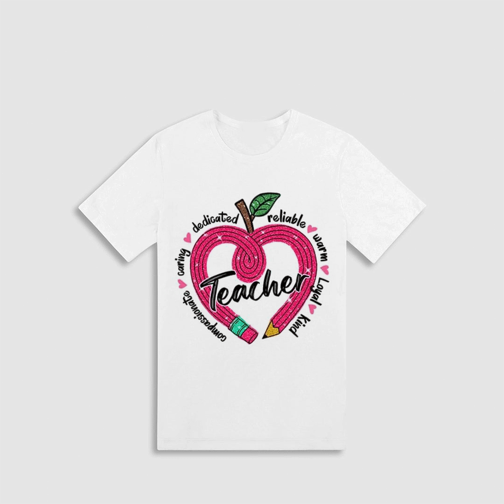 A white t-shirt with a graphic design featuring an apple with a heart shape and the word "Teacher" written inside it.