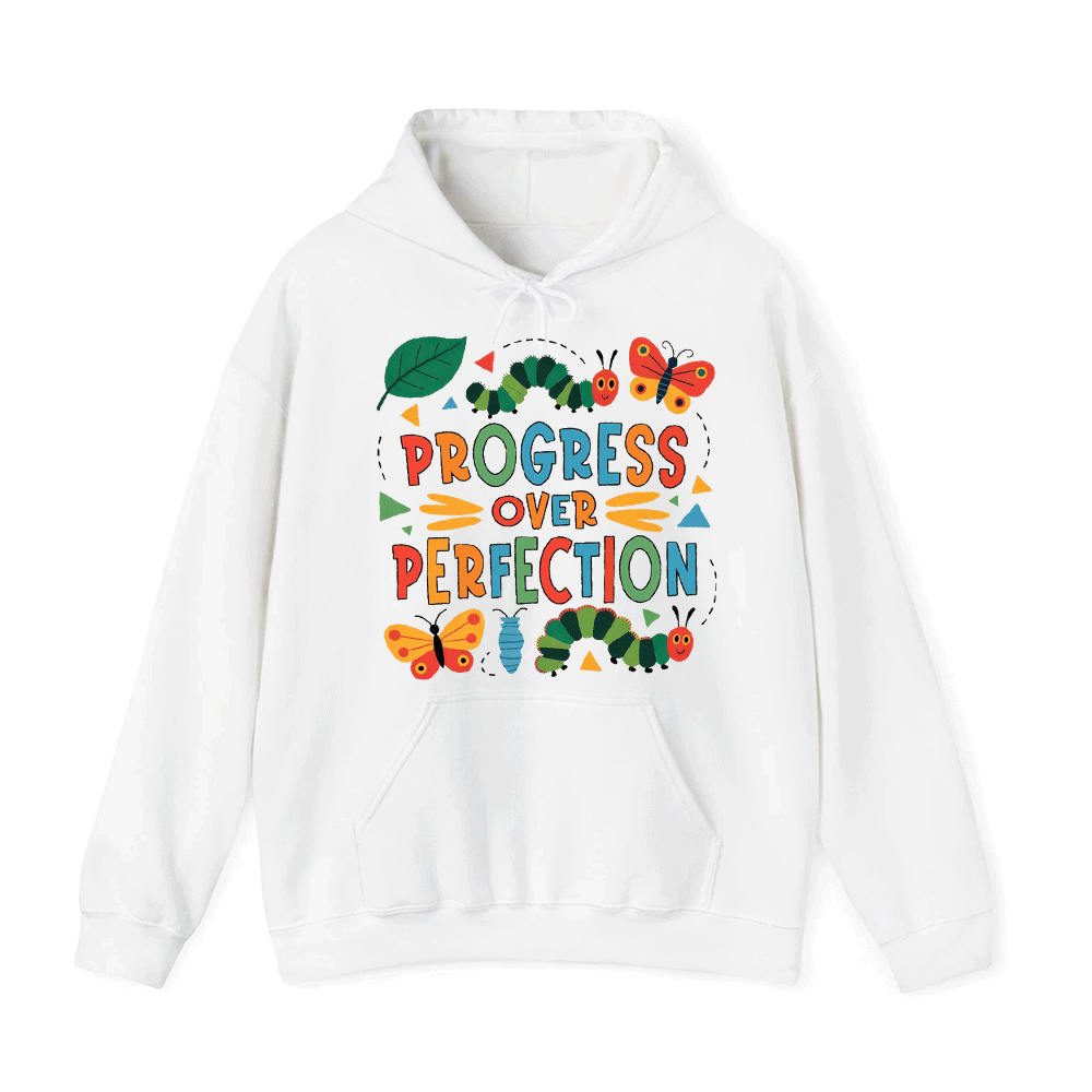 A white hoodie with a colorful graphic design featuring a caterpillar, butterflies, and the text "PROGRESS OVER PERFECTION".