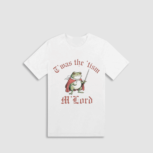 A white t-shirt with a graphic design featuring a frog wearing a cape and holding a sword, along with the text "I was the 'ism' M'lord" printed on it.