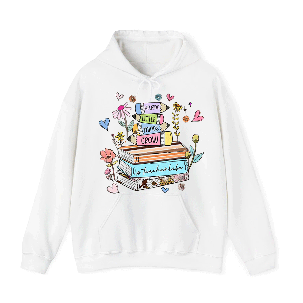 A white hoodie with a colorful graphic design featuring a stack of books surrounded by flowers, hearts, and other decorative elements.