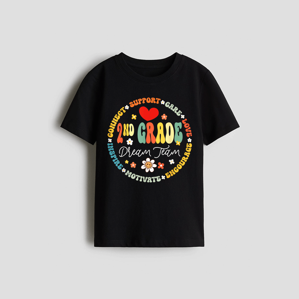 A black t-shirt with a colorful circular design featuring the text "2nd Grade Dream Team" surrounded by various motivational phrases such as "Connect", "Support", "Love", "Believe", "Dream", "Motivate", "Enourage", and "Chourage".