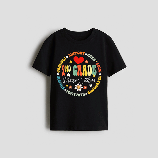 A black t-shirt with a colorful circular design featuring the text "2nd Grade Dream Team" surrounded by various motivational phrases such as "Connect", "Support", "Love", "Believe", "Dream", "Motivate", "Enourage", and "Chourage".