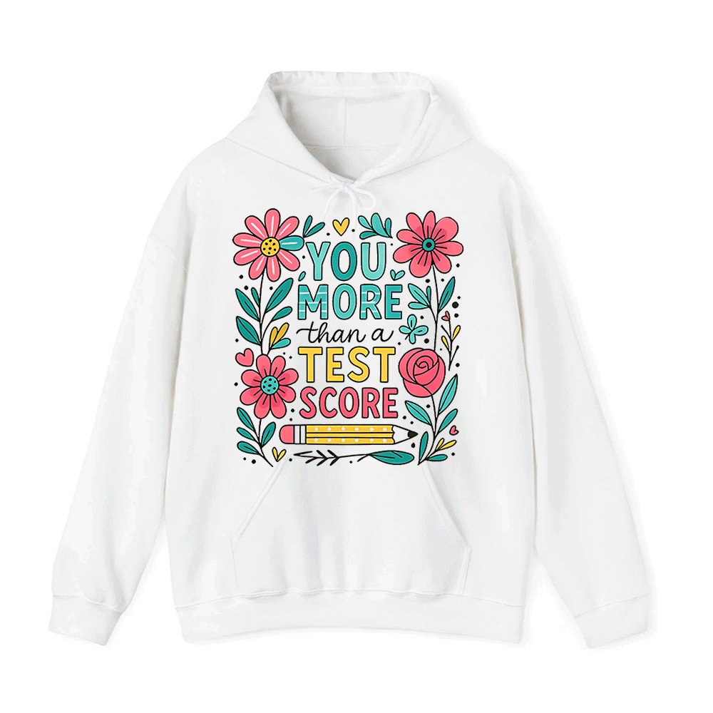 A white hoodie with a colorful graphic design featuring flowers, leaves, and a pencil. The text on the hoodie reads "YOU MORE THAN A TEST SCORE".