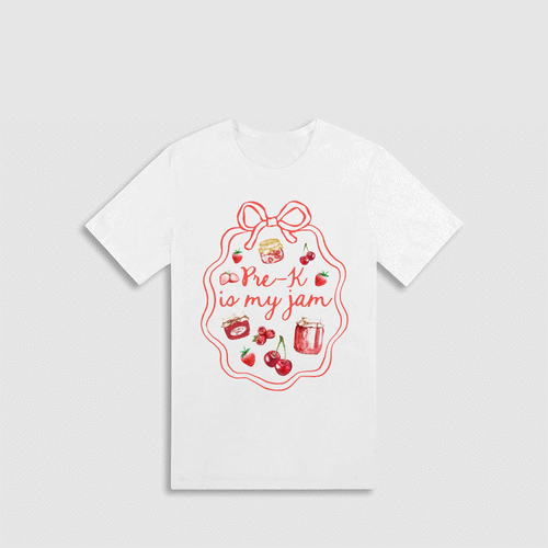A white t-shirt with a red graphic design featuring a bow, cherries, and a jar of jam, along with the text "Pre-K is my jam" written in a cursive font.