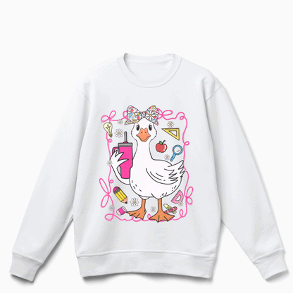 A white sweatshirt with a cartoon image of a duck wearing a bow and surrounded by various school supplies.