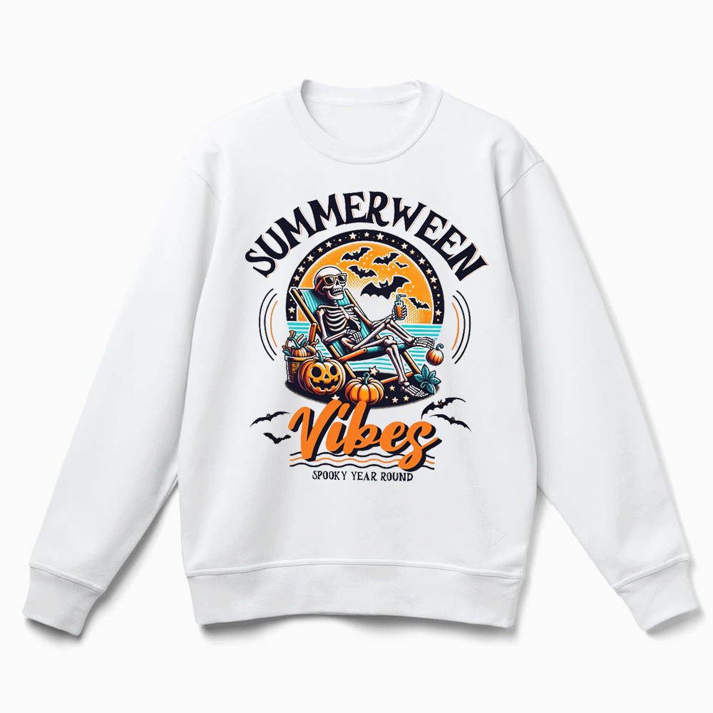 A white sweatshirt with a graphic design featuring a skeleton sitting on a rock, holding a pumpkin and surrounded by bats, with the text "SUMMERWEEN VIBES" and "SPOKE 'YEAR ROUND" printed on it.