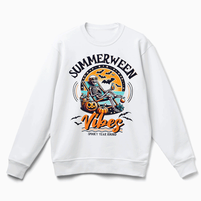 A white sweatshirt with a graphic design featuring a skeleton sitting on a rock, holding a pumpkin and surrounded by bats, with the text "SUMMERWEEN VIBES" and "SPOKE 'YEAR ROUND" printed on it.